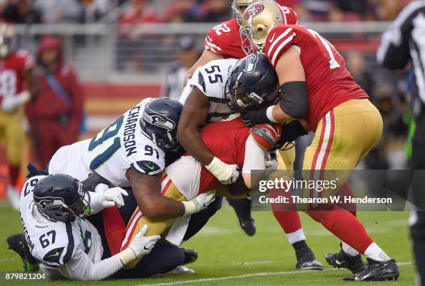 Beathard of the San Francisco 49ers gets sacked by Sheldon Richardson, Frank Clark and Branden Jackson of the Seattle Seahawks during their NFL...