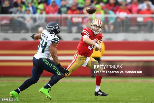 Beathard of the San Francisco 49ers gets his pass off under pressure from Bobby Wagner of the Seattle Seahawks during their NFL football game at...