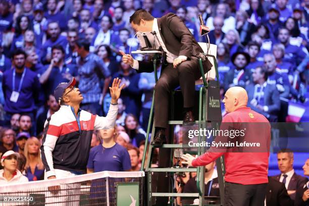 Captain of France Yannick Noah and captain of Belgium Johan Van Herck call the referee during day 3 of the Davis Cup World Group final between France...