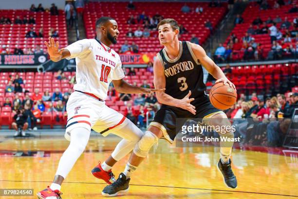 Fletcher Magee of the Wofford Terriers handles the ball against Niem Stevenson of the Texas Tech Red Raiders during the game on November 22, 2017 at...