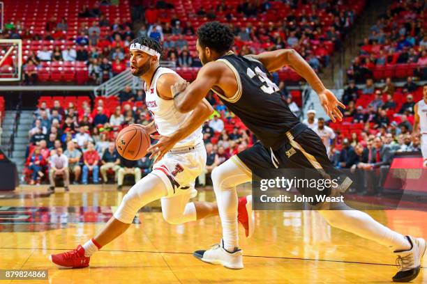 Brandone Francis of the Texas Tech Red Raiders drives to the basket against Donovan Theme-Love of the Wofford Terriers during the game on November...