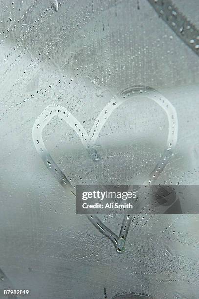 heart drawn on fogged window - mirror steam stock-fotos und bilder