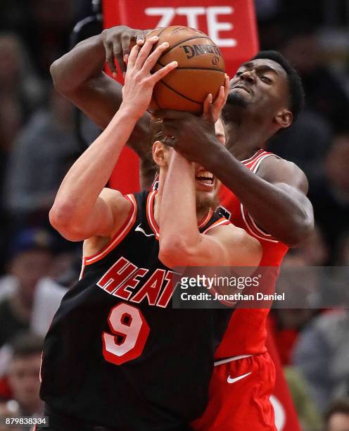 Kelly Olynyk of the Miami Heat and Bobby Portis of the Chicago Bulls battle for a rebound at the United Center on November 26, 2017 in Chicago,...