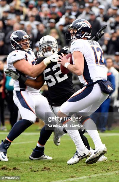 Denver Broncos quarterback Paxton Lynch drops back to pass during the first quarter on November 26, 2017 in Oakland, CA at Oakland-Alameda County...