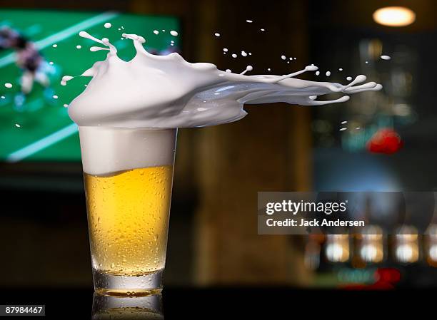 beer splashing out of pint glass - beer splash stock pictures, royalty-free photos & images