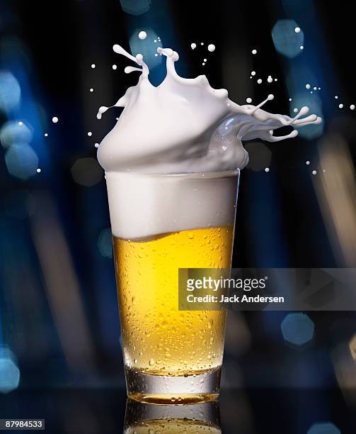 glass of beer with splashing foam - beer splashing stock pictures, royalty-free photos & images