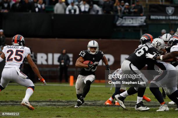 Running Back DeAndre Washington of the Oakland Raiders runs with the ball during the first quarter of his NFL football game against the Denver...