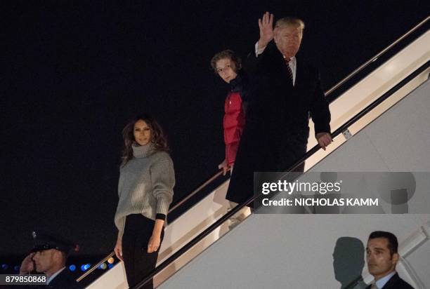 President Donald Trump , his son Barron and First Lady Melania Trump step off Air Force One at Andrews Air Force Base in Maryland on November 26,...