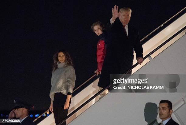 President Donald Trump , his son Barron and First Lady Melania Trump step off Air Force One at Andrews Air Force Base in Maryland on November 26,...
