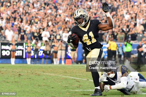 Alvin Kamara of the New Orleans Saints is chased down by John Johnson of the Los Angeles Rams during the fourth quarter at the Los Angeles Memorial...