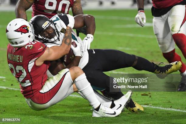 Leonard Fournette of the Jacksonville Jaguars is tackled by Tyrann Mathieu of the Arizona Cardinals in the second half at University of Phoenix...