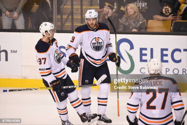 Connor McDavid, Leon Draisaitl and Milan Lucic of the Edmonton Oilers celebrate an empty net goal against the Boston Bruins at the TD Garden on...