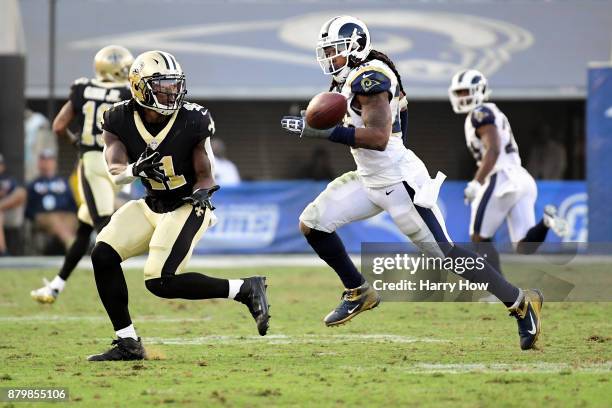Alvin Kamara of the New Orleans Saints makes a catch in front of John Johnson of the Los Angeles Rams for a big gain during the fourth quarter at the...