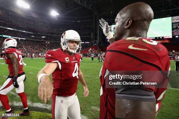 Kicker Phil Dawson of the Arizona Cardinals celebrates with running back Adrian Peterson following the NFL game against the Jacksonville Jaguars at...