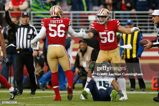 Reuben Foster and Brock Coyle of the San Francisco 49ers celebrate after tackling Tyler Lockett of the Seattle Seahawks at Levi's Stadium on November...