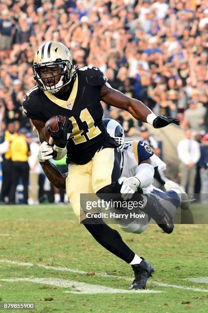 Alvin Kamara of the New Orleans Saints is chased down by John Johnson of the Los Angeles Rams during the fourth quarter at the Los Angeles Memorial...