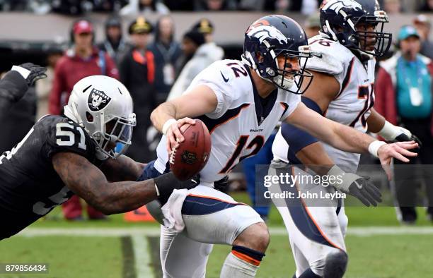 Oakland Raiders outside linebacker Bruce Irvin sacks Denver Broncos quarterback Paxton Lynch during the second quarter on November 26, 2017 in...
