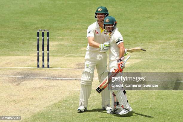 David Warner of Australia embraces Cameron Bancroft of Australia after winning the test during day five of the First Test Match of the 2017/18 Ashes...
