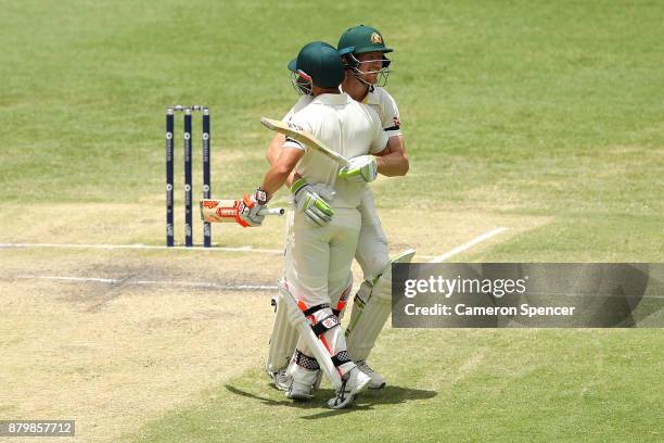 David Warner of Australia embraces Cameron Bancroft of Australia after winning the test during day five of the First Test Match of the 2017/18 Ashes...