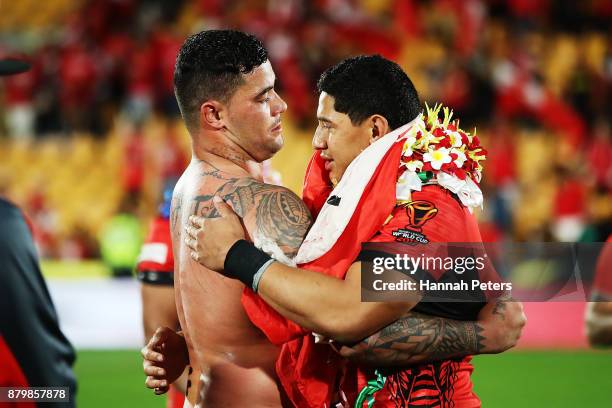 Andrew Fifita and Jason Taumalolo of Tonga embrace after losing the 2017 Rugby League World Cup Semi Final match between Tonga and England at Mt...