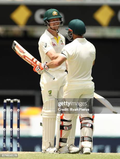 Cameron Bancroft and David Warner of Australia celebrate after hitting the winning runs during day five of the First Test Match of the 2017/18 Ashes...