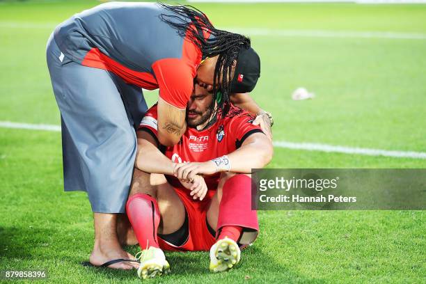 Konrad Hurrell of Tonga is comforted after losing the 2017 Rugby League World Cup Semi Final match between Tonga and England at Mt Smart Stadium on...