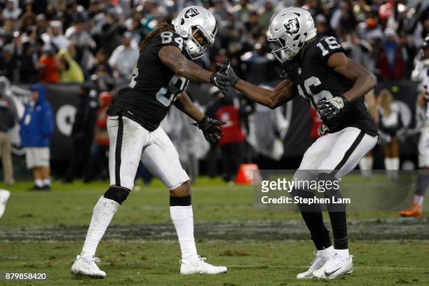 Cordarelle Patterson of the Oakland Raiders is being congratulated by teammate Johnny Holton after a 54-yard gain during the fourth quarter of their...