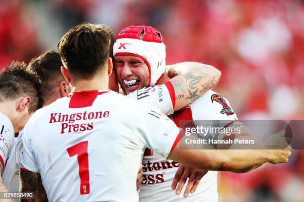 Chris Hill celebrates with Gareth Widdop of England during the 2017 Rugby League World Cup Semi Final match between Tonga and England at Mt Smart...