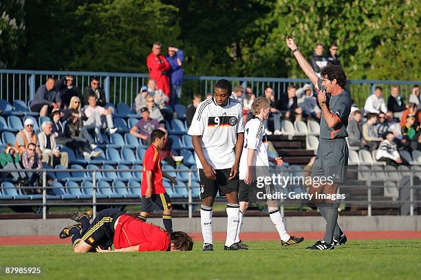 Richard Sukuta-Pasu of Germany gets the yellow card from referee Mauro Bergonzi during the U19 Euro Qualifier match between Spain and Germany at the...