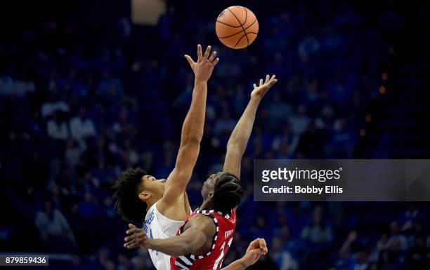 Nick Richards of the Kentucky Wildcats and Tai Odiase of the Illinois-Chicago Flames battle for the ball during the tip-off to the game between the...