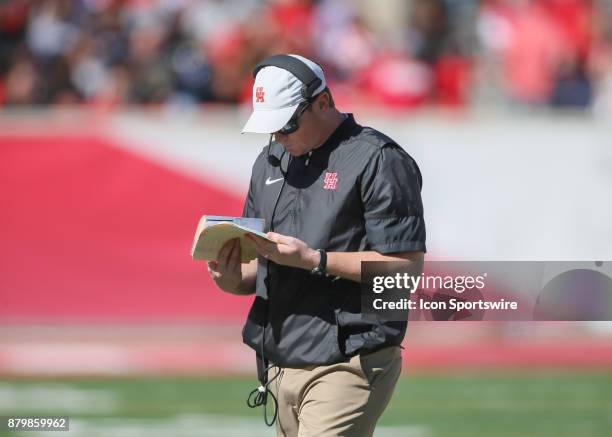 Houston Cougars head coach Major Applewhite checks playbook during the football game between the Navy Midshipmen and Houston Cougars on November 24,...