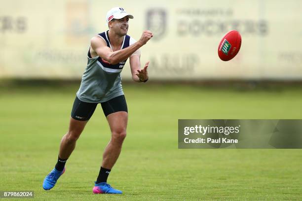 Stephen Hill of the Dockers handballs during a Fremantle Dockers AFL pre-season training session at Victor George Kailis Oval on November 27, 2017 in...
