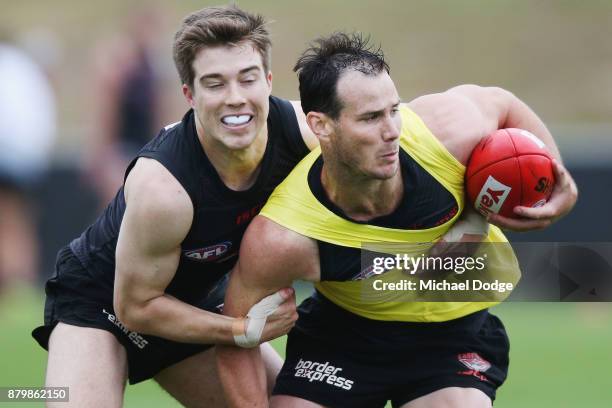 Zach Merrett tackles Matt Dea during an Essendon Bombers AFL training session at the Essendon Bombers Football Club on November 27, 2017 in...