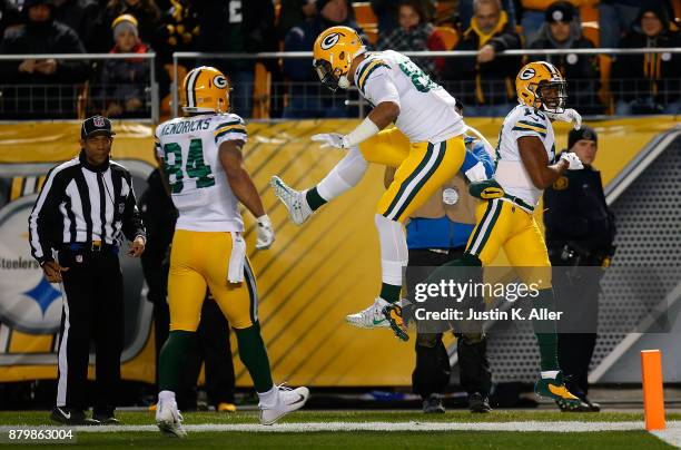 Randall Cobb of the Green Bay Packers celebrates with Richard Rodgers after a 39 yard touchdown reception in the first quarter during the game...