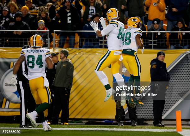 Randall Cobb of the Green Bay Packers celebrates with Richard Rodgers after a 39 yard touchdown reception in the first quarter during the game...