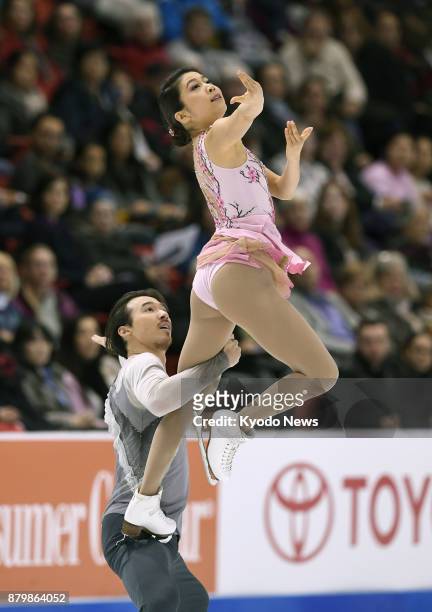 Japanese ice dancer Kana Muramoto and partner Chris Reed of the United States perform a lift in the free dance at Skate America in Lake Placid, New...