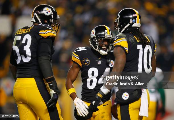 Antonio Brown of the Pittsburgh Steelers celebrates with Martavis Bryant and Maurkice Pouncey after a catch for a two point conversion in the second...