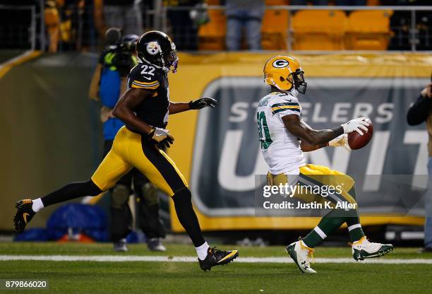 Jamaal Williams of the Green Bay Packers reacts after crossing the goal line for a 54 yard touchdown reception in the first quarter during the game...