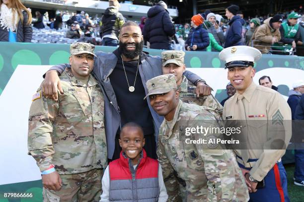 New York Knicks player Kyle O'Quinn greets service people when he attends the Carolina Panthers vs New York Jets game at MetLife Stadium on November...