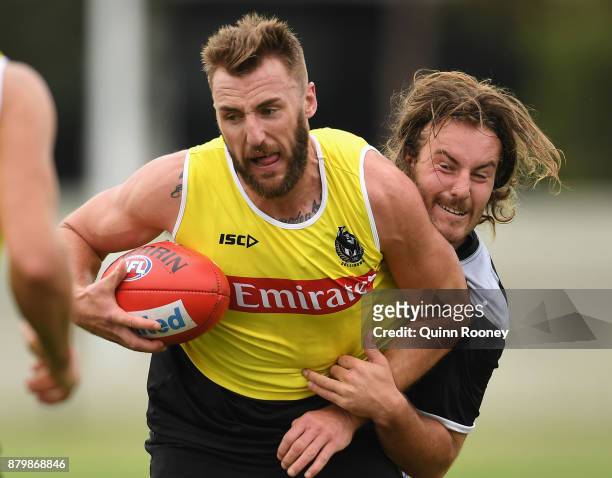 Lynden Dunn of the Magpies is tackled by Tim Broomhead during a Collingwood Magpies AFL training session at Holden Centre on November 27, 2017 in...