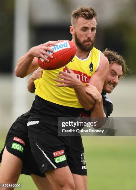 Lynden Dunn of the Magpies is tackled by Tim Broomhead during a Collingwood Magpies AFL training session at Holden Centre on November 27, 2017 in...