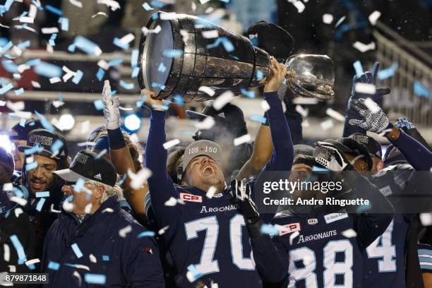 Lirim Hajrullahu of the Toronto Argonauts raises the Grey Cup after winning the 105th Grey Cup Championship Game against the Calgary Stampeders at TD...