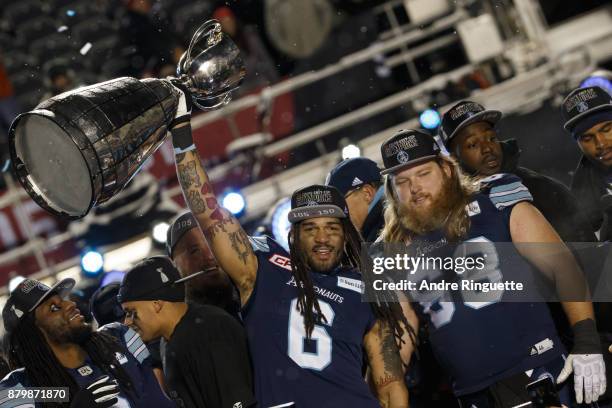 Marcus Ball and Chris Kolankowski of the Toronto Argonauts raise the Grey Cup after winning the 105th Grey Cup Championship Game against the Calgary...