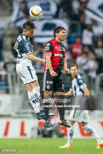 Jonathan Gonzalez of Monterrey heads the ball with Matias Alustiza of Atlas during the quarter finals second leg match between Tigres UANL and Leon...