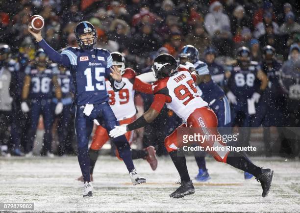 Ricky Ray of the Toronto Argonauts throws the ball as Ja'Gared Davis of the Calgary Stampeders defends against during the second half of the 105th...