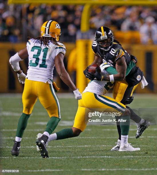 Martavis Bryant of the Pittsburgh Steelers is wrapped up for a tackle by Ha Ha Clinton-Dix of the Green Bay Packers in the second half during the...