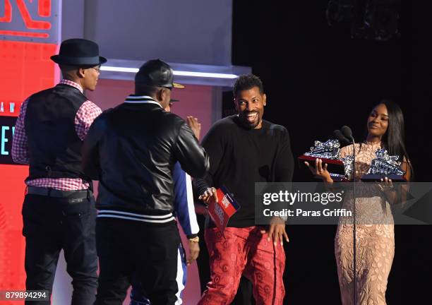 Ricky Bell and Ronnie DeVoe of Bell Biv DeVoe accept the Soul Train Certified Award from Deon Cole onstage at the 2017 Soul Train Awards, presented...