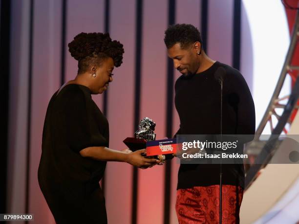 Ledisi accepts the Soul Train Certified Award from Deon Cole onstage at the 2017 Soul Train Awards, presented by BET, at the Orleans Arena on...