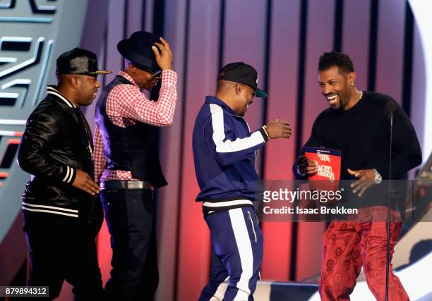Michael Bivins, Ronnie DeVoe, and Ricky Bell of Bell Biv DeVoe accept the Soul Train Certified Award from Deon Cole onstage at the 2017 Soul Train...