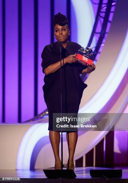 Ledisi accepts the Soul Train Certified Award from Deon Cole onstage at the 2017 Soul Train Awards, presented by BET, at the Orleans Arena on...